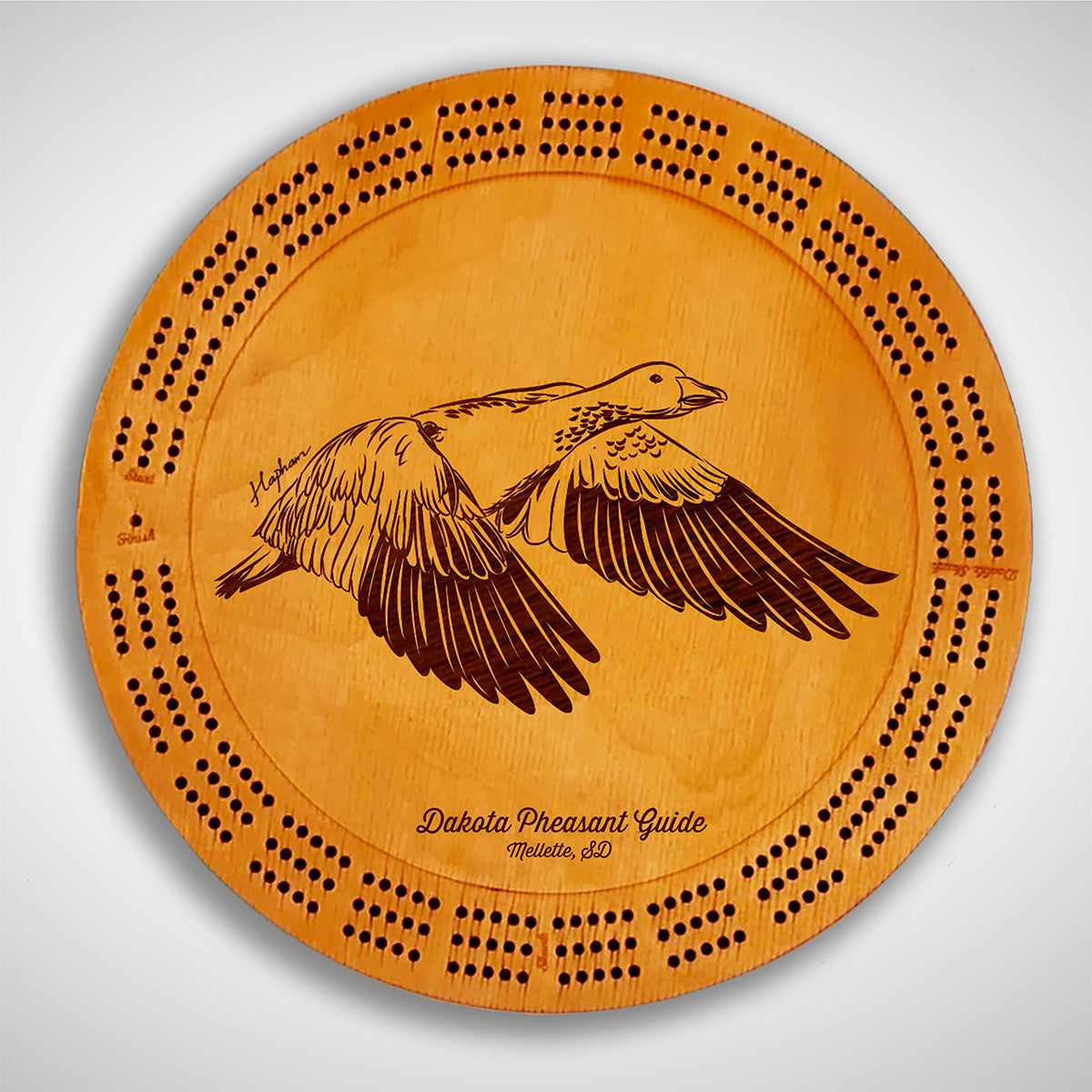 Crafted from high-quality wood, and featuring a laser-engraved Snow Goose in flight, this cribbage board allows you to bring memories of your outdoor adventures to your game. Enjoy the nostalgic feel and endless entertainment of this premium board. Show off your love for waterfowl and game birds while honing your cribbage skills. Perfect for any cabin or game room! A Dakota Pheasant Guide souvenir.