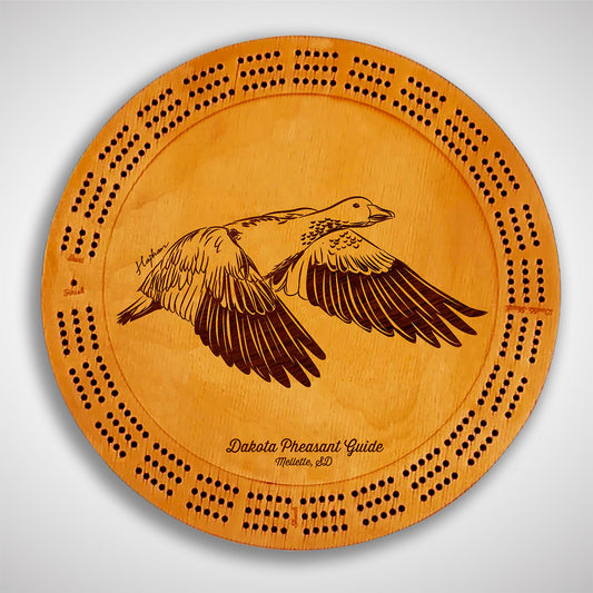 Crafted from high-quality wood, and featuring a laser-engraved Snow Goose in flight, this cribbage board allows you to bring memories of your outdoor adventures to your game. Enjoy the nostalgic feel and endless entertainment of this premium board. Show off your love for waterfowl and game birds while honing your cribbage skills. Perfect for any cabin or game room! A Dakota Pheasant Guide souvenir.