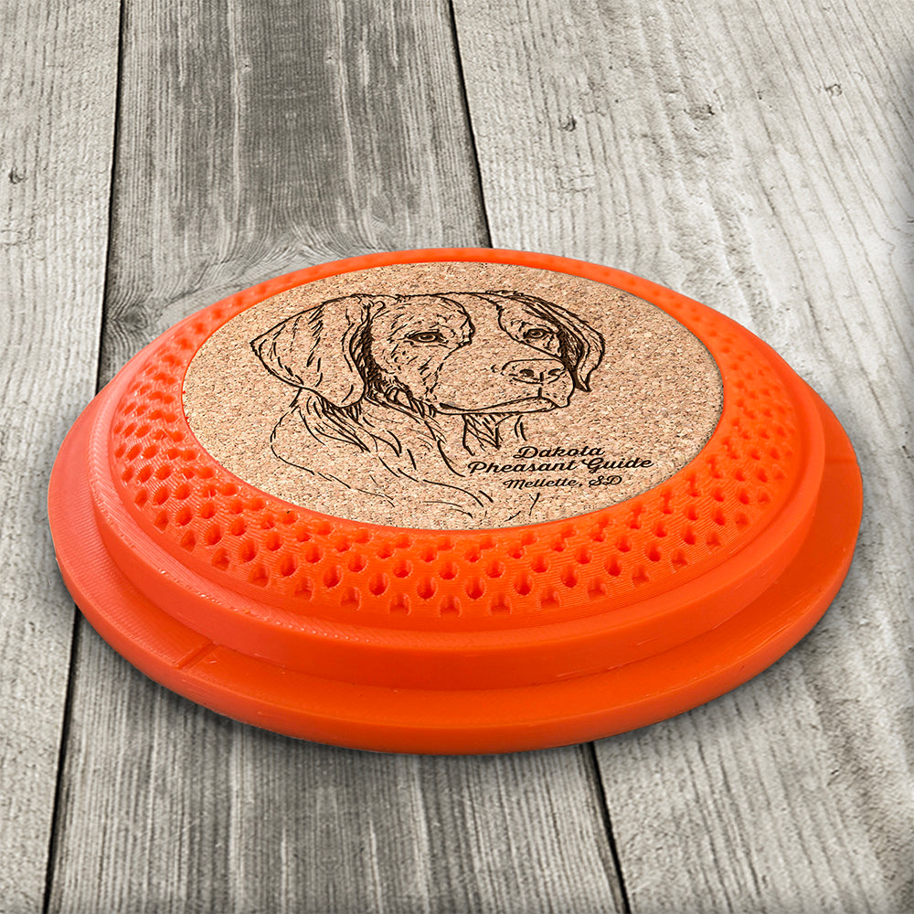 Clay Pigeon shaped coaster base with a laser-engraved cork insert featuring a Pheasant taking flight - this set of 4 coasters makes a unique gift for any trap shooter, gun enthusiast and bird dog lover! By Muggins Gifts for the Dakota Pheasant Guide Souvenir shop.