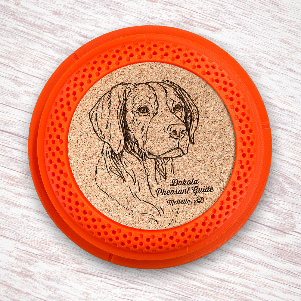 Clay Pigeon shaped coaster base with a laser-engraved cork insert featuring a Brittany Spaniel - this set of 4 coasters makes a unique gift for any trap shooter, gun enthusiast and bird dog lover! By Muggins Gifts for the Dakota Pheasant Guide Souvenir shop.