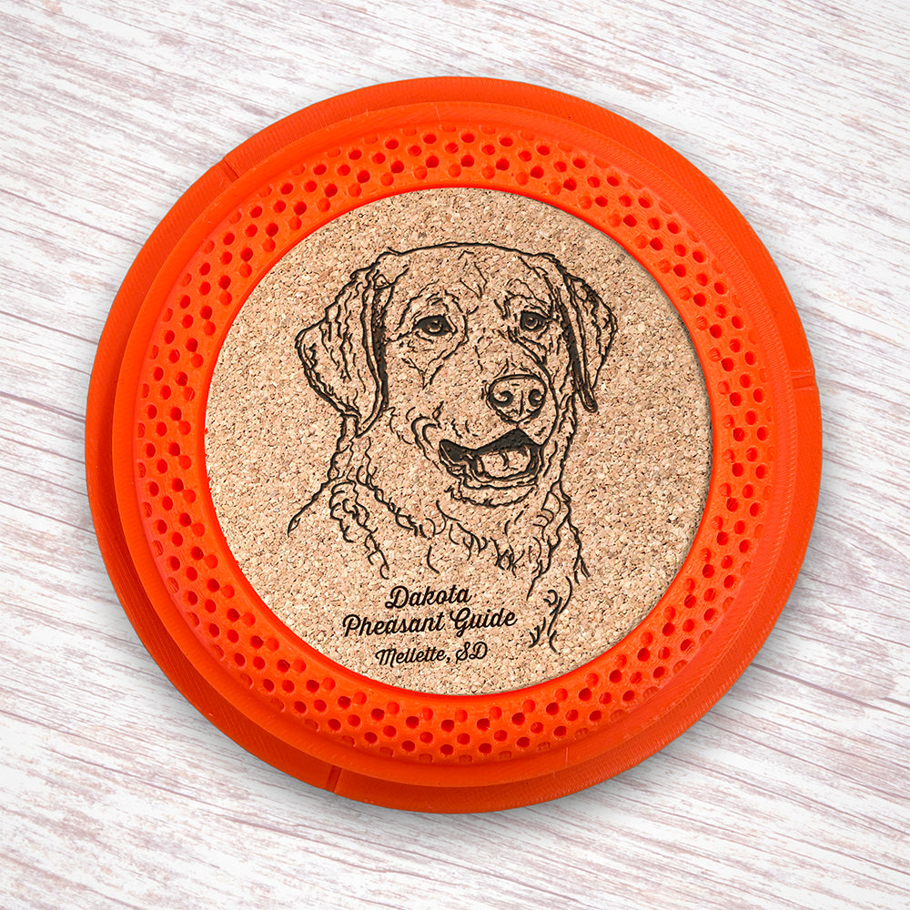 Clay Pigeon shaped coaster base with a laser-engraved cork insert featuring a Chesapeake Bay Retriever - this set of 4 coasters makes a unique gift for any trap shooter, gun enthusiast and bird dog lover! By Muggins Gifts for the Dakota Pheasant Guide Souvenir shop.