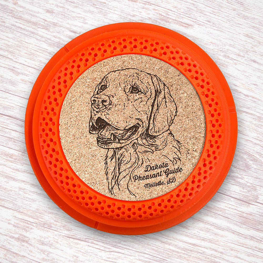 Clay Pigeon shaped coaster base with a laser-engraved cork insert featuring a Golden Retriever - this set of 4 coasters makes a unique gift for any trap shooter, gun enthusiast and bird dog lover! By Muggins Gifts for the Dakota Pheasant Guide Souvenir shop.