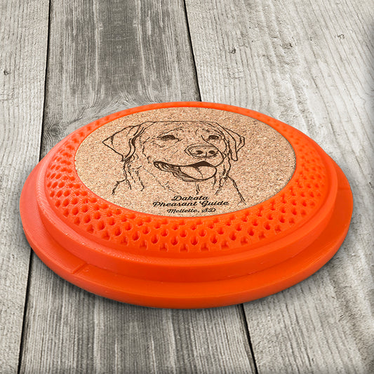 Clay Pigeon shaped coaster base with a laser-engraved cork insert featuring a Labrador Retriever - this set of 4 coasters makes a unique gift for any trap shooter, gun enthusiast and bird dog lover! By Muggins Gifts for the Dakota Pheasant Guide Souvenir shop.