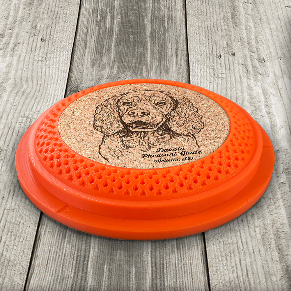 Clay Pigeon shaped coaster base with a laser-engraved cork insert featuring a Springer Spaniel - this set of 4 coasters makes a unique gift for any trap shooter, gun enthusiast and bird dog lover! By Muggins Gifts for the Dakota Pheasant Guide Souvenir shop.