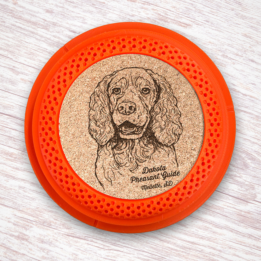 Clay Pigeon shaped coaster base with a laser-engraved cork insert featuring a Springer Spaniel - this set of 4 coasters makes a unique gift for any trap shooter, gun enthusiast and bird dog lover! By Muggins Gifts for the Dakota Pheasant Guide Souvenir shop.