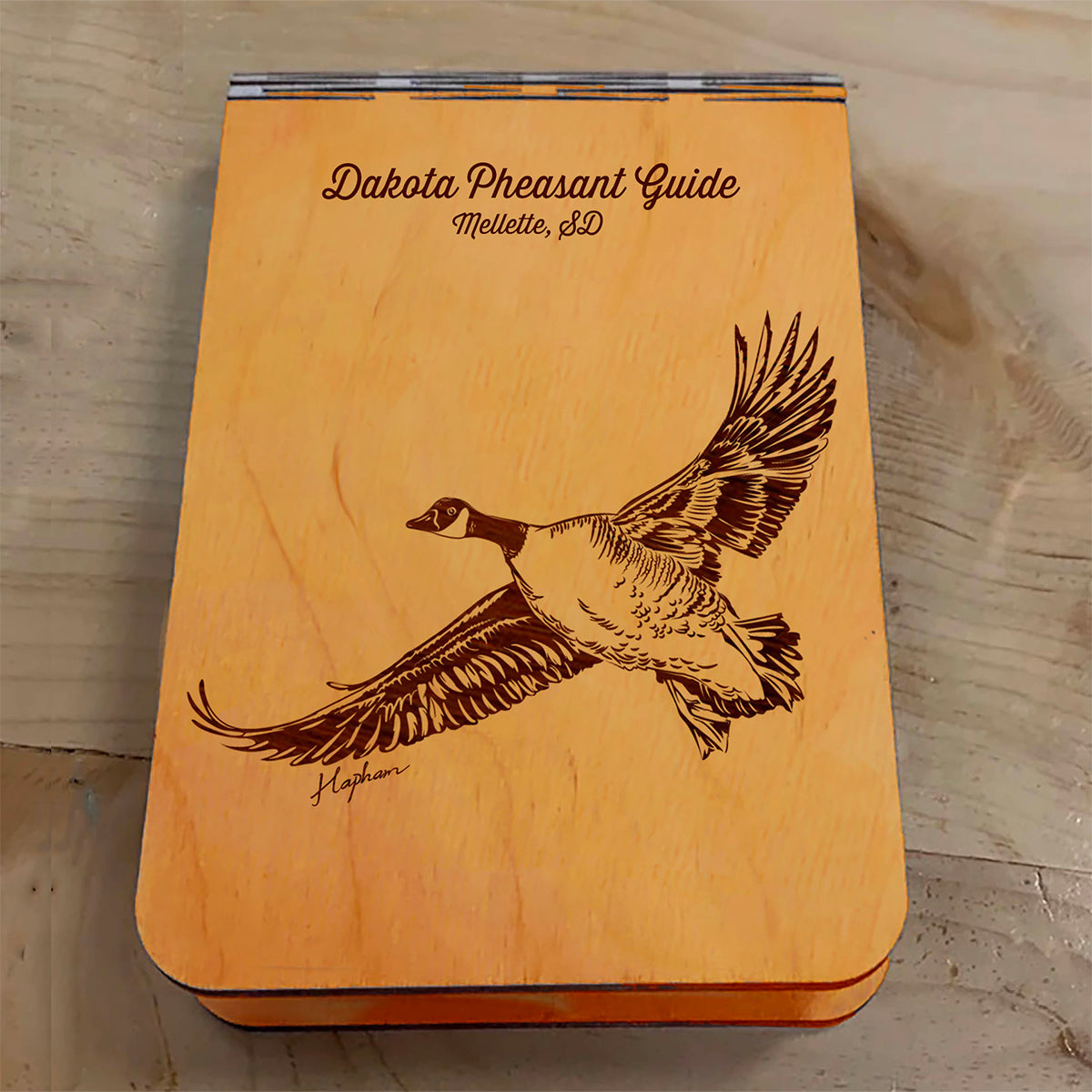 Featuring a laser-engraved Canada Goose in flight, this small wooden crib board is an ideal gift and travel companion for any game bird and waterfowl hunting enthusiast. Enjoy hours of fun on the go, and make your next adventure memorable with our Travel Crib Board! A Dakota Pheasant Guide souvenir.