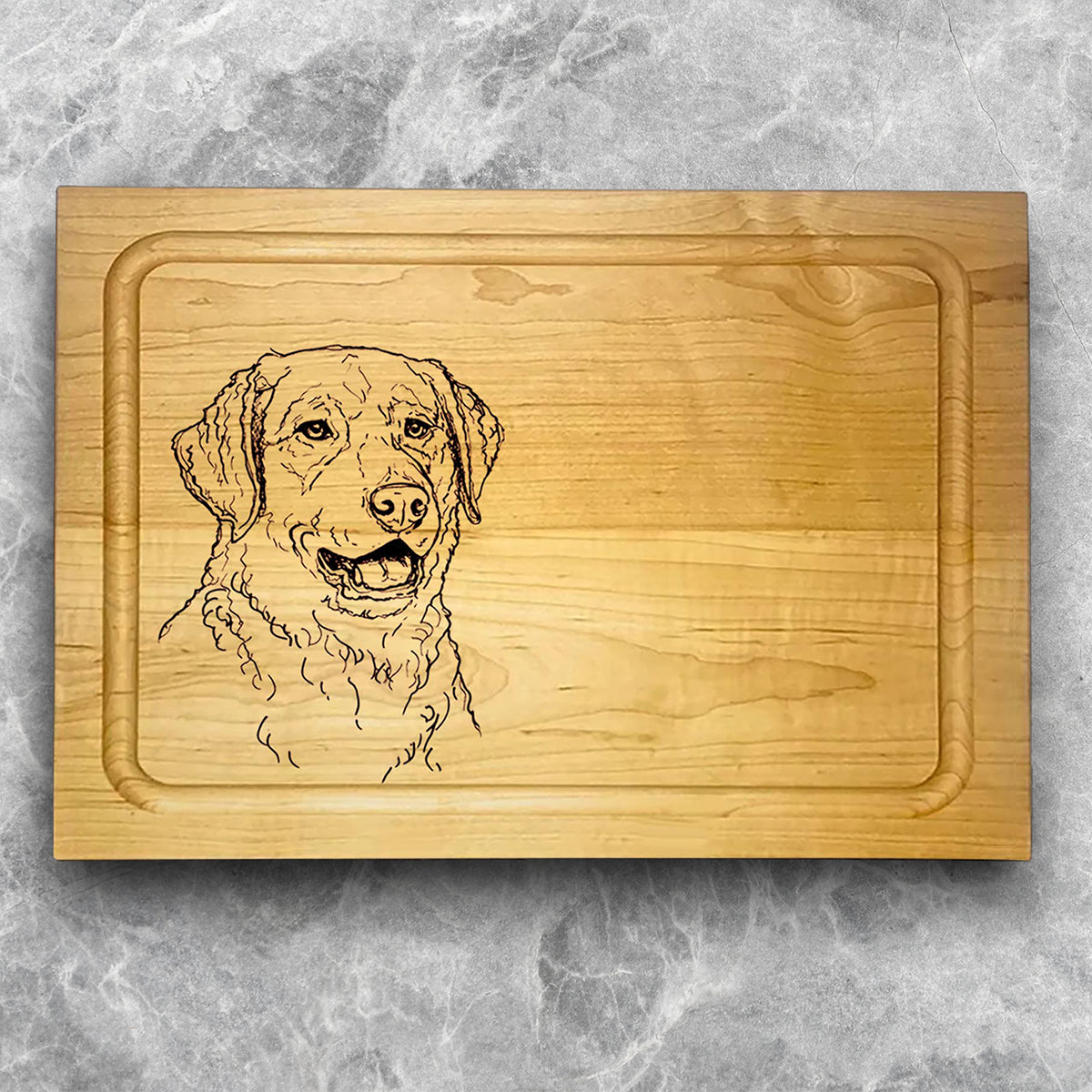 A high-quality, durable maple cutting board with juice groove featuring a laser-engraved Chesapeake Bay Retriever. A perfect addition for any kitchen, and a wonderful reminder of your love of hunting and sporting dogs. A Dakota Pheasant Guide souvenir.