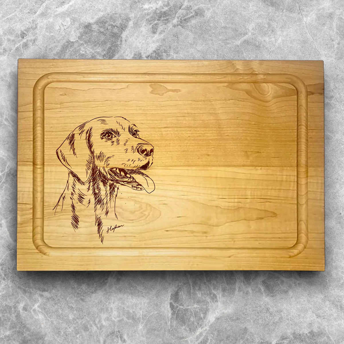 A high-quality, durable maple cutting board with juice groove featuring a laser-engraved German Shorthair Pointer. A perfect addition for any kitchen, and a wonderful reminder of your love of hunting and sporting dogs. A Dakota Pheasant Guide souvenir.