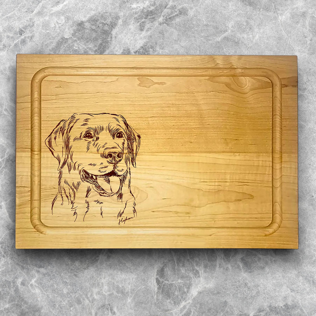 A high-quality, durable maple cutting board with juice groove featuring a laser-engraved Labrador Retriever. A perfect addition for any kitchen, and a wonderful reminder of your love of hunting and sporting dogs. A Dakota Pheasant Guide souvenir.