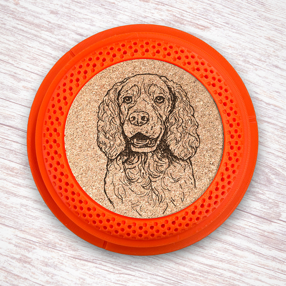 Clay Pigeon shaped coaster base with a laser-engraved cork insert featuring a Springer Spaniel - this set of 4 coasters makes a unique gift for any trap shooter, gun enthusiast and bird dog lover! By Muggins Gifts for the Dakota Pheasant Guide Souvenir shop.