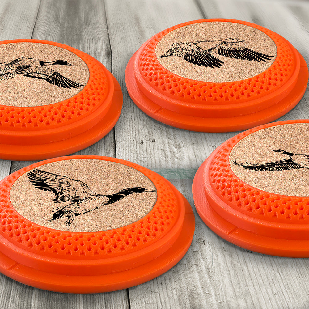 Clay Pigeon shaped coaster bases with laser-engraved cork inserts, featuring a Mallard Duck, Pintail Duck, Snow Goose, and a Canada Goose - this set of 4 waterfowl coasters makes a unique gift for any trap shooter, gun enthusiast and game bird lover! By Muggins Gifts for the Dakota Pheasant Guide Souvenir shop.